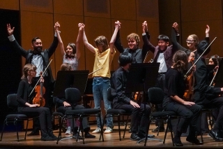 Members of the Metropolitan Youth Symphony standing for applause at the end of a performance