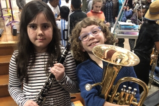 Two members of Oregon Bravo Youth Orchestras, one holding a hornclarinet and one holding a 