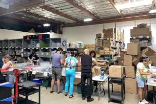 Volunteers sorting supplies in a warehouse