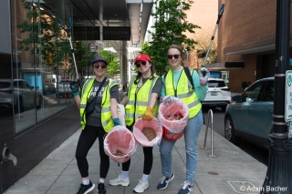 Three AdoptOneBlock volunteers cleaning up downtown streets