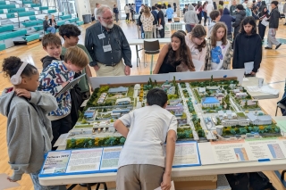 Young students looking at a Pathways 2050 modeling exhibit