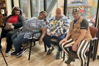 Four people sitting in chairs