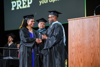 A person receiving a diploma at a graduation ceremony
