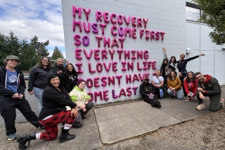 Group photo of people with signage that says: My recovery must come first so that everything I love in life doesn't have to come last.
