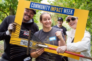 United Way of Columbia-Willamette volunteers holding a rake and working at Zenger Farm during Community Impact Week