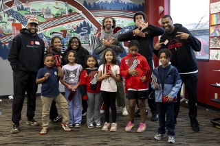 Group photo of adults and kids dressed in Portland Trail Blazers gear