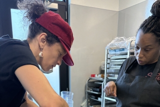 Two people in a kitchen mixing batter