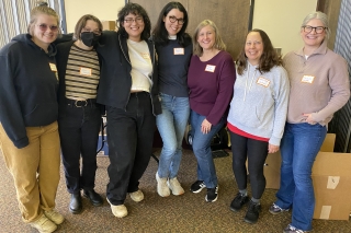 A group photo of volunteers wearing name tags