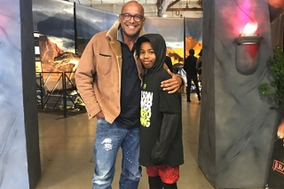 Man and boy at dinosaur exhibit