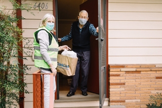 Man receiving a food delivery at his home