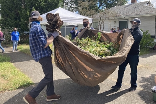 REACH Community Development volunteers doing yardwork