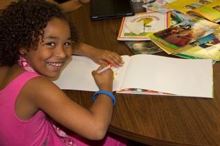 SMART Reading girl with a coloring book