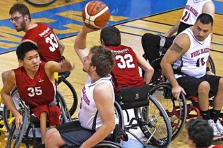 Photo of men in wheelchairs playing basketball