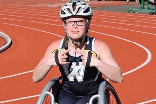 Photo of a girl in a wheelchair on a track