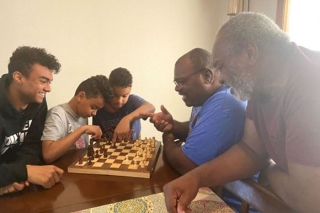 Photo of a family playing chess