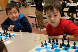 Photo of a boy playing chess