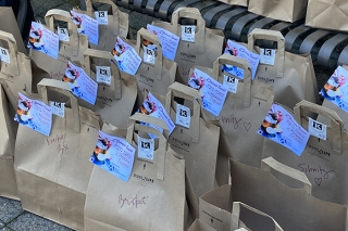Paper bags containing brisket ready to be distributed