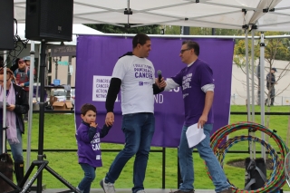 Photo of a father and young son on stage at Pancreatic Cancer Action Network event