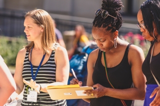 Photo of women and a signup sheet