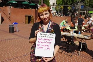 Photo of woman holding a sign of support