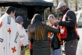 Photo of American Red Cross with people who've lost their home