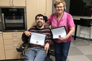 Photo of a woman and a man in a wheelchair
