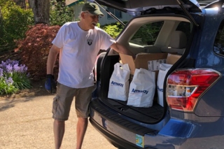 Photo of a man loading a car with supplies