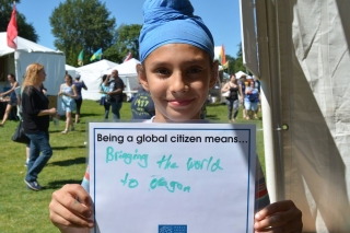 Photo of a girl with a global citizen sign