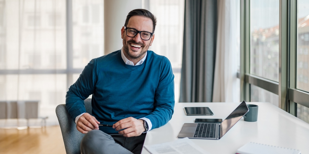 Confident smiling human resources manager with laptop.