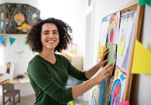 Woman in classroom at bulletin board