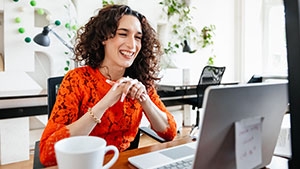 Social Media Toolkit: Share How Clients Can Cover More of Their Salaries A woman at her desk