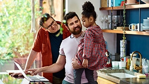 Social Media Toolkit: Share How Clients Can Cover More of Their Salaries Two dads with their daughter
