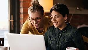 Two women looking at a laptop