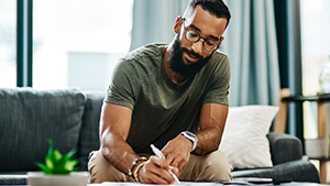 A man sitting on a couch working