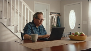 Social Media Toolkit: Help Protect Client Income With Platinum Advantage Doug working on a laptop