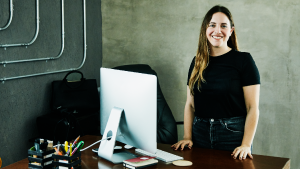 A woman standing at her desk