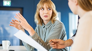 Social Media Toolkit: Help Clients Increase Their Income Protection With the Benefit Increase Rider Two professional women talking with each other