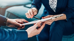 Social Media Toolkit: Help Clients Increase Their Income Protection With the Benefit Increase Rider Hands holding on to a clipboard