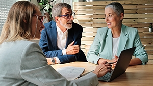 A man and a woman talking with a financial professional