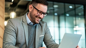 Social Media Toolkit: Help Your Client Use the Convenient Electronic Medical Questionnaire A person using their laptop in a conference room