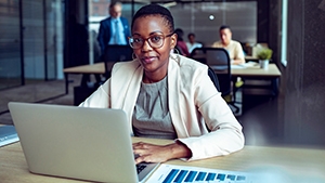 A person with a laptop in an office