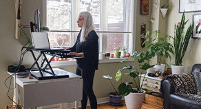 A woman at a stand-up desk