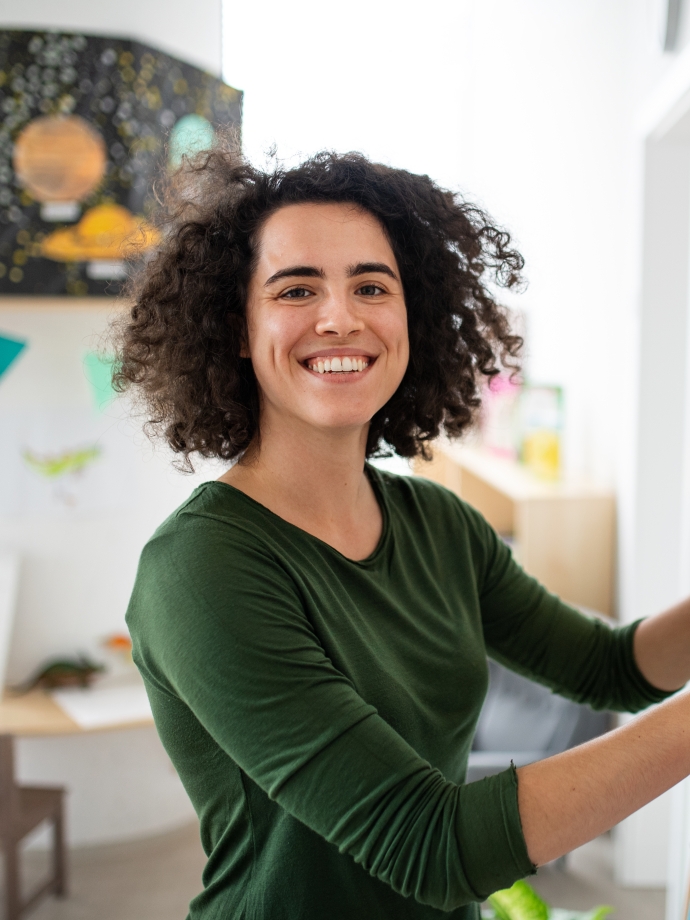 Woman in classroom at bulletin board